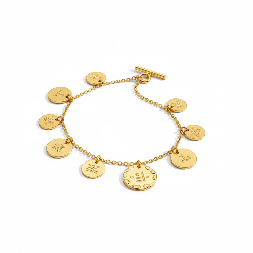 Gold plated coin charm bracelet with multiple disc charms on white background